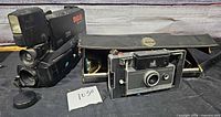 Polaroid Automatic 100 camera beside RCA 23X camcorder