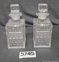 Both Fostoria decanters side by side showing overall design and condition