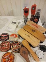 Full lot view showing brushes, polish tins, sprays, cleaners