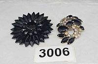 Front view of both brooches showing designs and colours