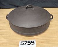 Top view of brown stoneware casserole with lid showing handles and form