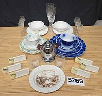 All items in lot – sugar bowl, flow blue setting, Villeroy & Boch bowls, white bowls, glassware, name holders, souvenir plate