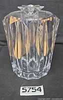 Full view of clear faceted lucite ice bucket with starburst lid finial