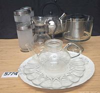 All items grouped: Wedgwood platter, glass platter, glass teapot, Copco kettle, carafe, shakers, trifle bowls