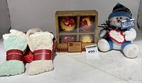 Front view showing Lane ornament box, two Olive Olivia sock bundles, snowman plush