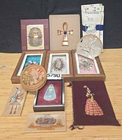 Overall lot showing framed pieces, carved shell, tapestry, plate hanger packages and smaller decorative items