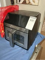 Front three-quarter view of Gourmia air fryer showing pull-out basket and MaxSold tag