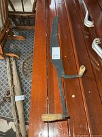 Full view of hay saw on table, both wooden handles visible
