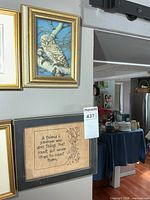 Both framed pieces hanging: 3-D owl art above stitched quote art
