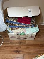 box with folded blankets visible