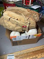 Top view of glove on box of softballs