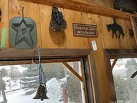 Overall view showing tin star plaque, pulley, sign, cowboy silhouette, bell