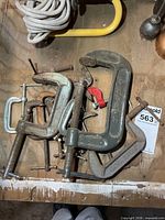 Group of assorted C-clamps on work surface