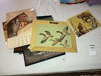 Pile of calendars with Savage display on top