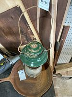 Full view of Coleman CNR lantern hanging by bail handle, showing overall form and missing globe