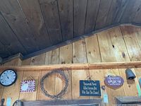 Overall shot showing signs, wreath, thermometer area on wood wall