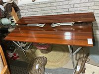 folding wooden slat picnic table upside down showing aluminum folding legs