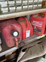 Shelf view of large red fuel can and Motorcraft coolant jug