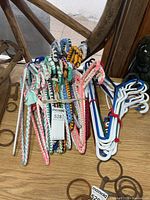Bundle of braided fabric hangers and plastic hangers on tabletop