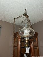 Full view of hanging light with chains and ceiling mount