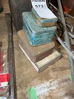 Stacked view of four tins showing colors and general wear