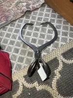 Full view of ice tongs laid flat on floor
