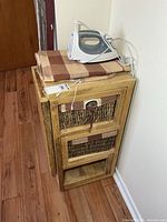 Cabinet closed with baskets, iron and cover on top