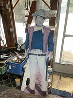 Front view of full standee leaning on ladder