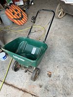 Overall view of Golfgreen spreader, green hopper, wheels, handle