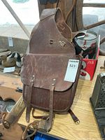 Full view of one saddle bag showing flap, straps, and yoke