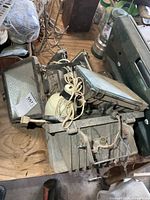 Overall view of two floodlight fixtures showing housings, cords and brackets