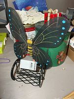 Napkin holder and butterfly together, size reference with tag