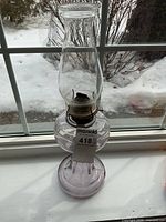 Full view of amethyst glass oil lamp with chimney