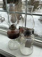 Both glass oil lamps side by side showing overall form and height