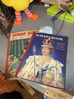 Two scrapbooks on table showing covers