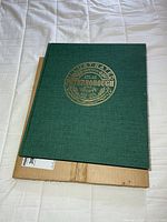 Front cover showing green cloth and gilt title crest