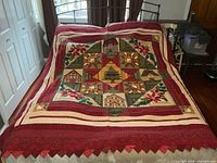 Full view of handmade quilt spread on bed showing overall design and borders