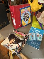 Overall lot showing binder, Baseball Superstars Album, NHL hockey sticker book, My Sticker Album