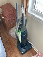 Front view of Kenmore upright vacuum with hose, wand and bag pack