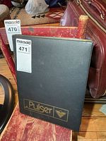 Closed Pulser binder leaning on chair