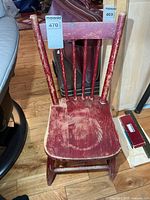 Front view of red wooden child’s chair
