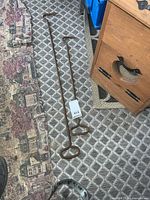 Full view of both stove pokers with length tag