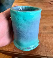 Side view of mug showing glaze colours and flaking at foot