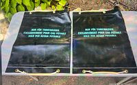Front view of both black Swiss Military water storage bags showing text and size