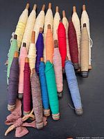 Group of 22 colored thread wooden spools