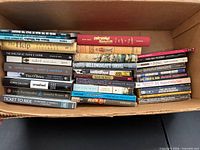 Box containing assorted books, spines visible