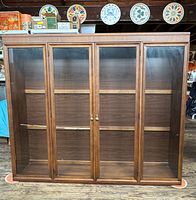 Front view of Broyhill Brasilia cabinet showing four glass doors and interior shelves