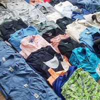 Closer angle of mixed tees, polos and jackets highlighting colours and tags