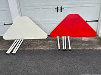 Both triangular Ikea table tops with corresponding legs laid out