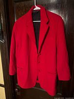 Front view of red Donna Karan blazer on hanger